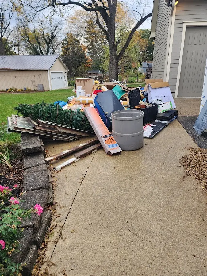 Dumpster being loaded with debris for Estate Cleanout Dumpster Rental in Doney Park